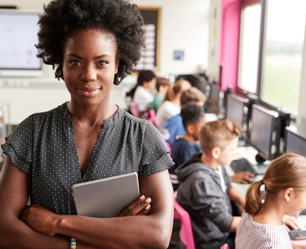 A teacher smiling in front of her class